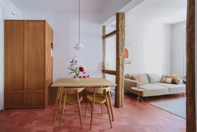 Un llamativo suelo rojo de WOW cerámica en la reforma de una vivienda en Madrid